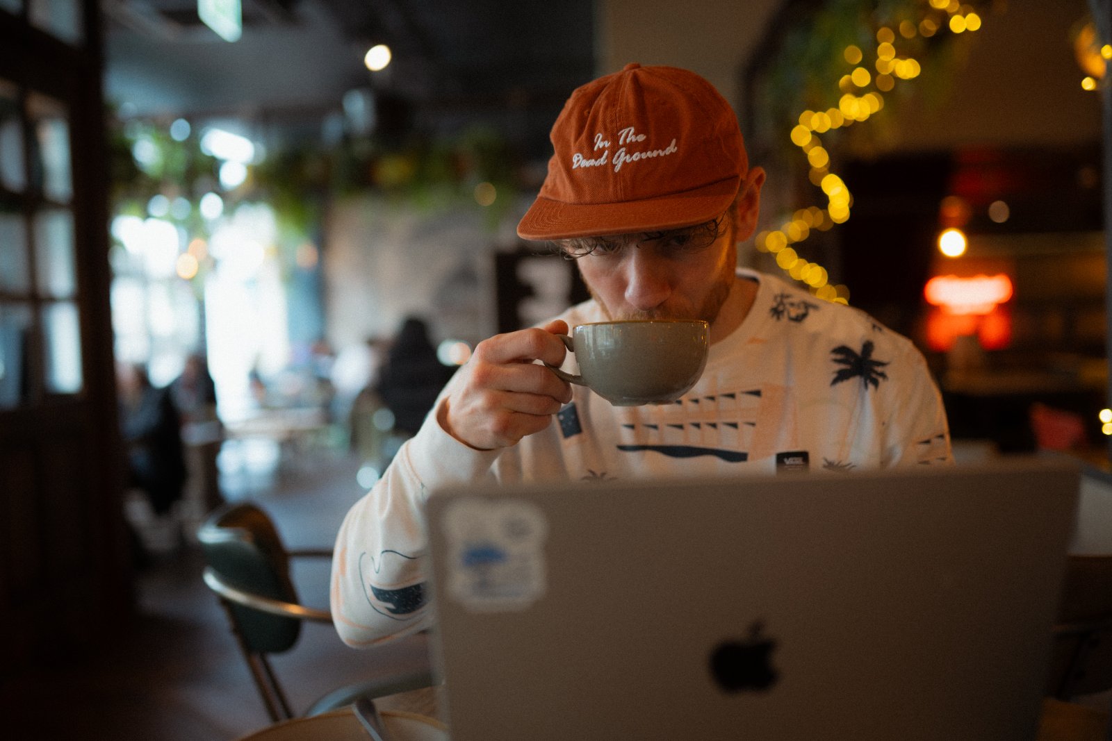 A person reviewing a training diary at a kitchen table in early morning light