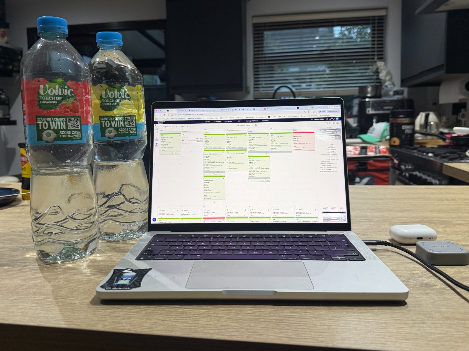 Two full 1.5 litre water bottles standing ready on a kitchen worktop in morning light